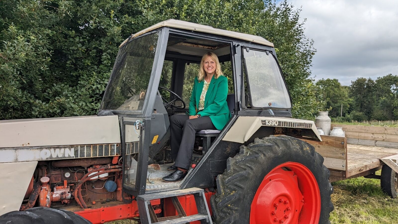 Carolyn Thomas sits in a tractor at an award winning local farm in Treuddyn